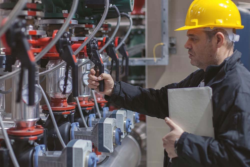 engineer inspects industrial equipment