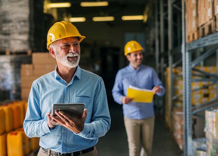 Warehouse workers with tablets