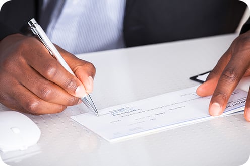 Person Writing a Business Cheque