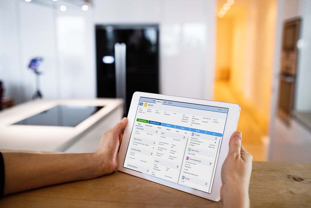 Close-up of hands using a tablet displaying a mobile app