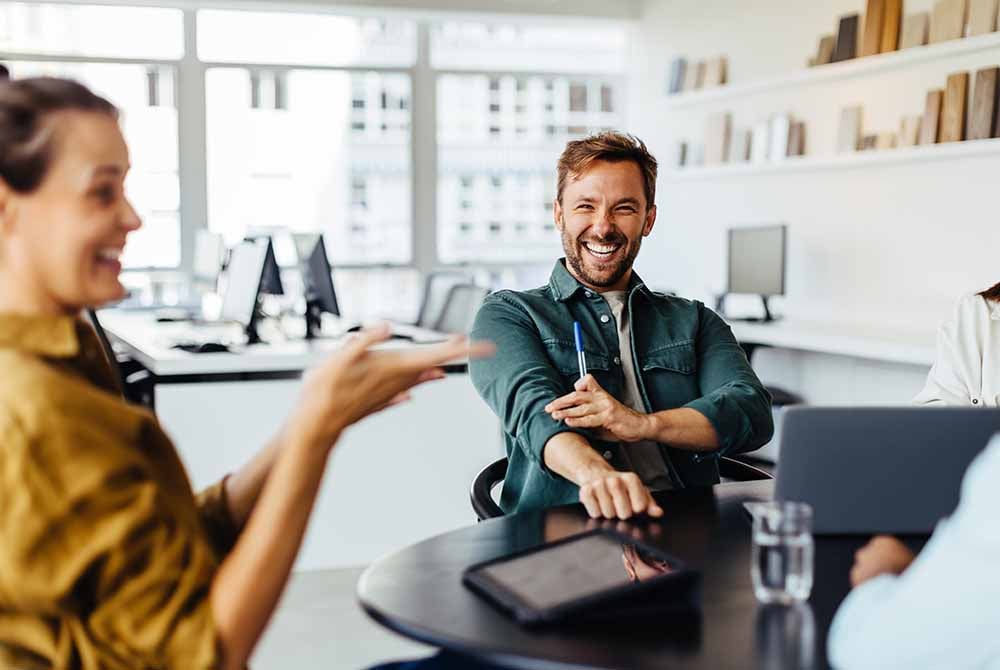 Team of professionals laughing together during a meeting