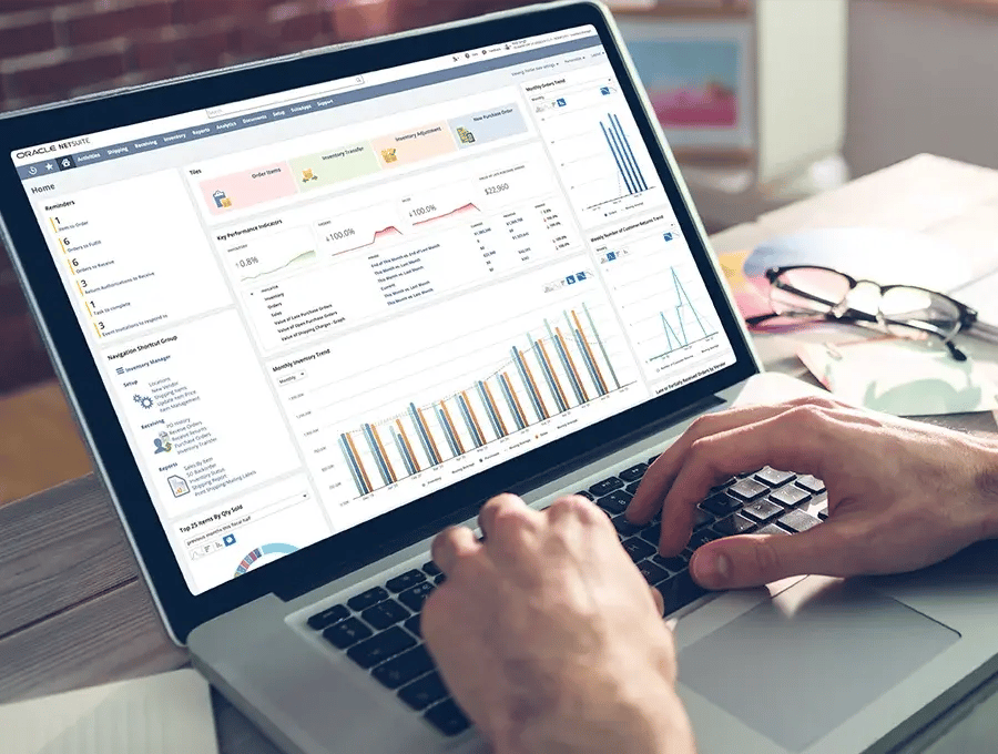 Laptop screen displaying NetSuite ERP software dashboard