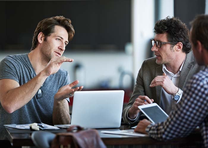Two professionals having a discussion, representing ProjectLine’s ERP support services to optimize and maintain business systems
