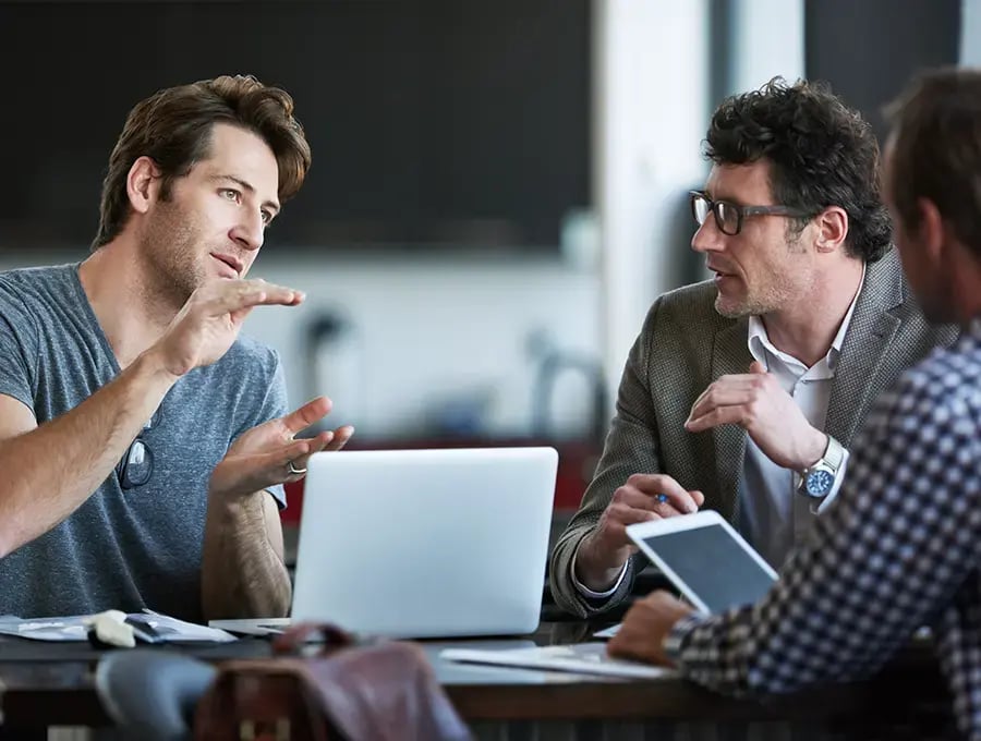 Two professionals having a discussion, representing ProjectLine’s ERP support services to optimize and maintain business systems