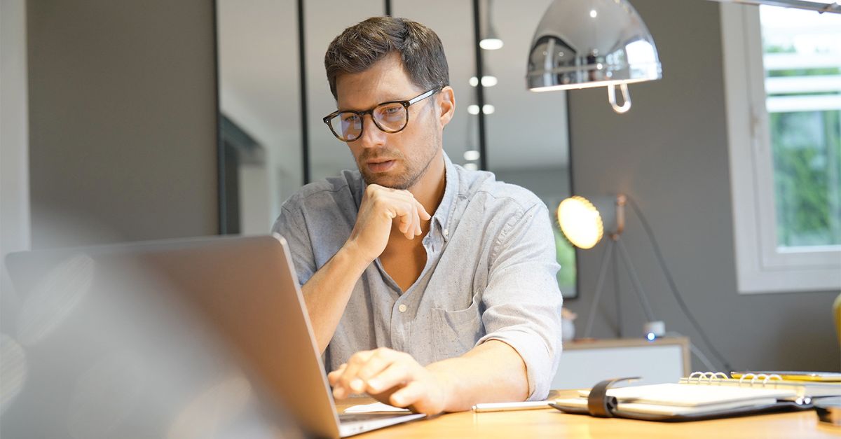 business man looking at laptop screen showing concern