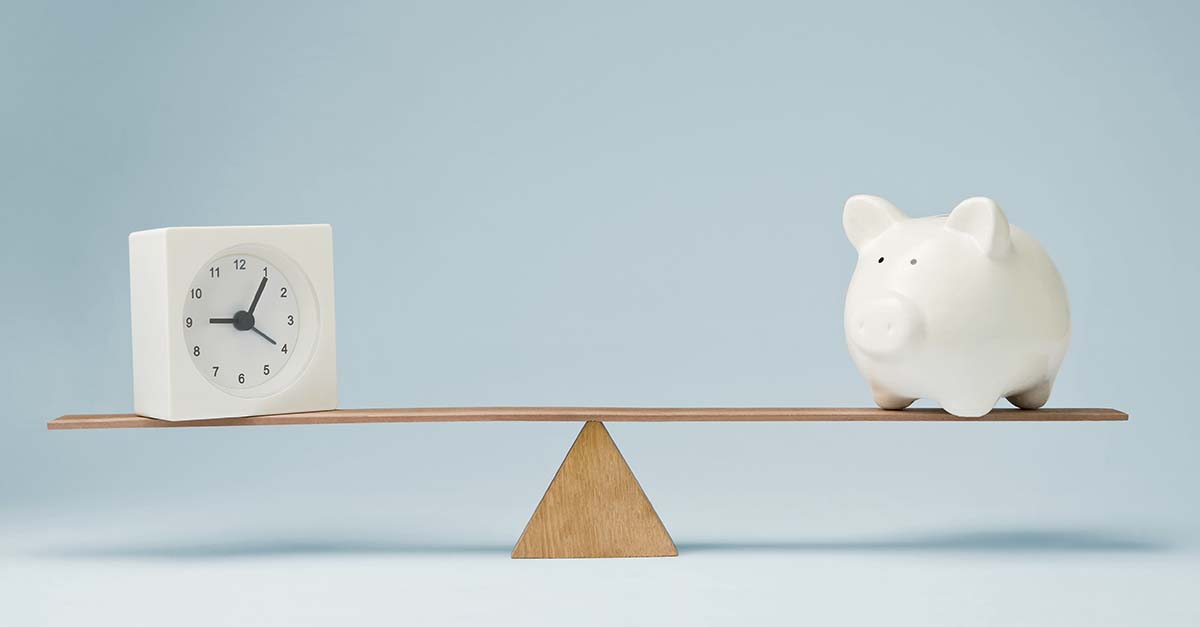 Balance scale with clock and piggy bank