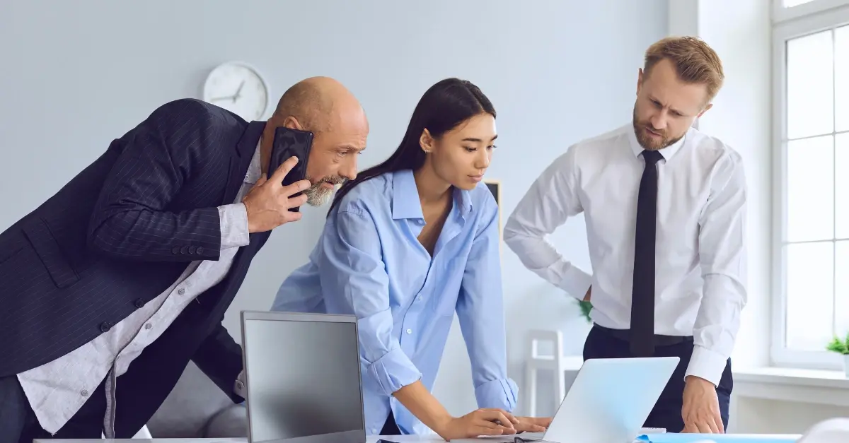Business team looking over laptop